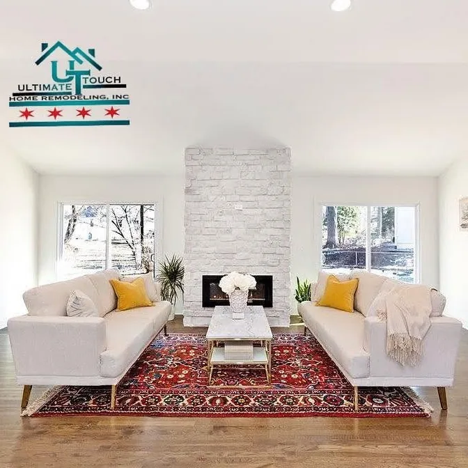 Finished living room with a floor-to-ceiling whitewashed stone fireplace, hardwood floors and daylight from windows on both sides